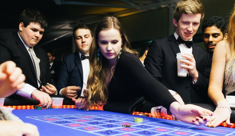 Интеллигентные игроки развлекаются за игрой в рулетку в престижном казино